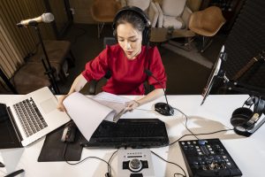 high-angle-woman-working-radio-with-professional-equipment