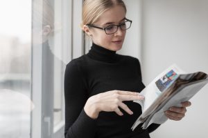 side-view-young-female-reading-magazine